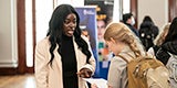 student gets information from participating Pitt2Pitt program during resource fair