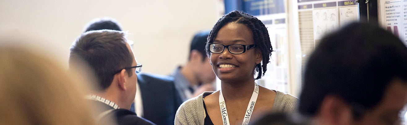 student presenting a poster at a lab session