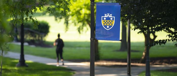 student walking on Pitt's Oakland campus in spring