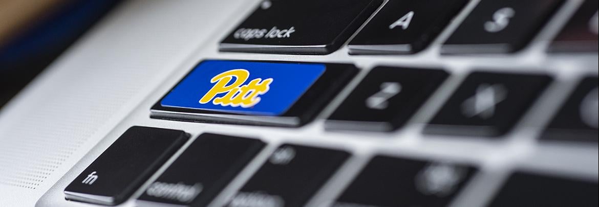 closeup of laptop keyboard with Pitt sticker on Shift key