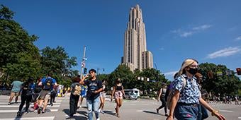Pitt students crossing intersection near Cathedral of Learning