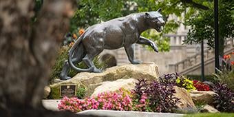panther statue with summer flowers
