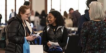Students visit a resource table at a Pitt2Pitt event