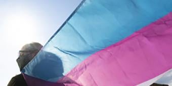 student carrying trans flag