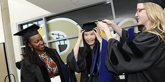 graduating students prepping their caps and gowns before ceremony