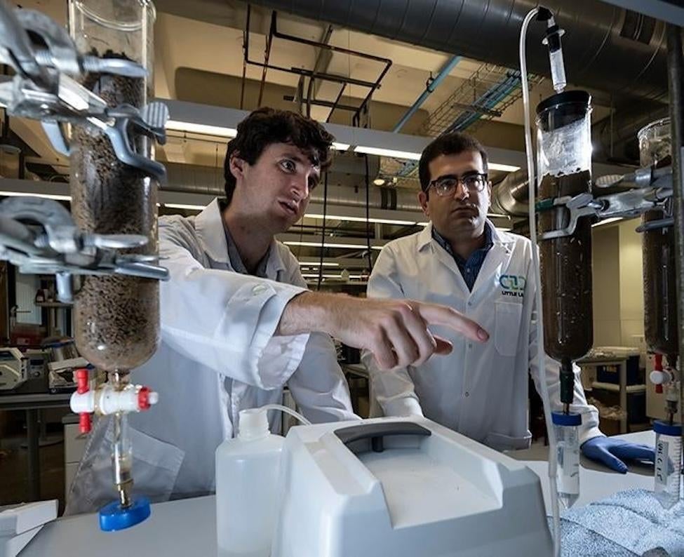 Two men working in lab coats in a research lab